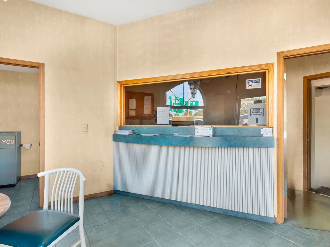 The front desk in the lodge office, with a service window and a seating area
