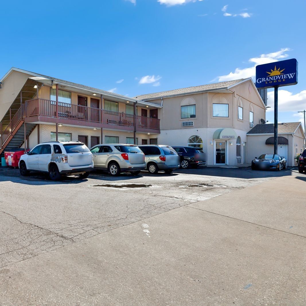 The Grandview Lodge office and two-story wing, with the navy Grandview Lodge pole sign under a blue sky