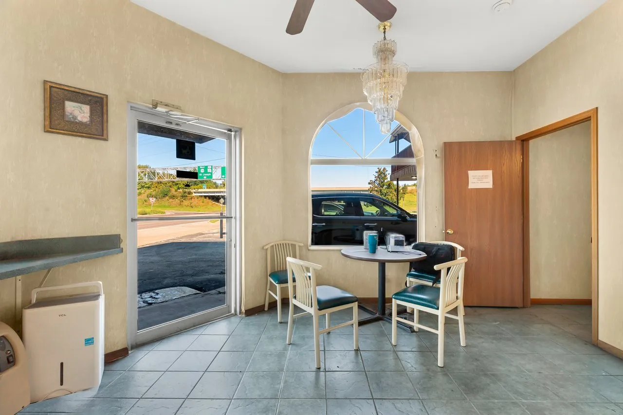 The lobby by the front door, with a small table, chairs and an arched window