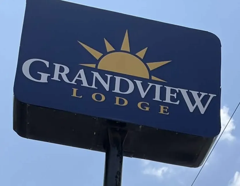 The navy Grandview Lodge pole sign with a gold sun